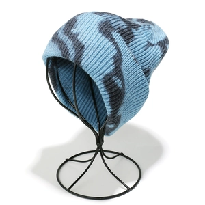 Detailed close-up of light blue and black zebra pattern knitted beanie with cuff