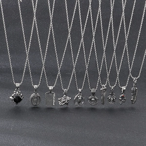 Detailed flat lay of punk titanium steel pendants including cross, star and feather charms