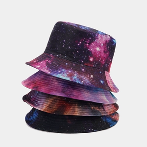Vertical stack of four bucket hats featuring diverse galaxy and nebula print patterns