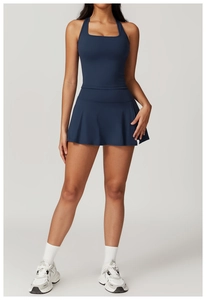 Detail of navy blue racerback fitness top and pleated sports skirt with elastic fabric