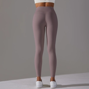 Rear view of high waisted yoga leggings in mauve fabric showing flattering seam details