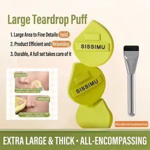 Makeup set featuring large green powder puffs and a flat foundation brush for wet use