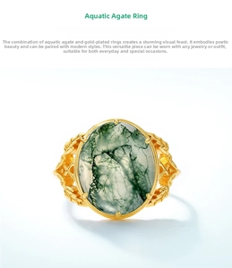 Macro detail of moss agate ring with oval green gemstone and ornate golden engraving