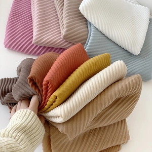 Close-up of pleated cotton-linen texture scarves in various vibrant colors