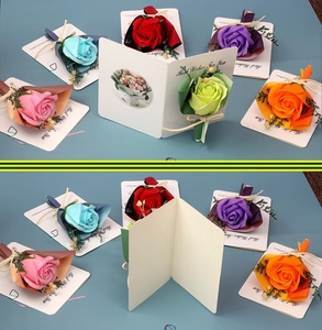 Flat lay of colorful soap rose greeting cards with Best Wishes text on blue background