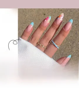 Detail of French press-on nails with light blue tips and delicate floral patterns