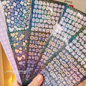 Detail of four holographic alphabet and number stickers for idol card decoration
