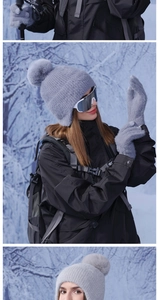 Close-up of light gray knit pom-pom beanie and matching gloves for winter outdoor use