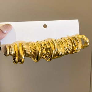 Macro shot of gold textured and smooth metal rings set on white display card
