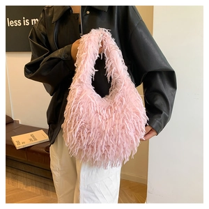 Chic pink faux fur shoulder bag with soft fluffy texture styled with a black leather jacket