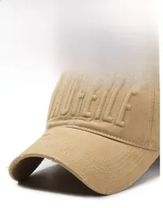 Close-up of khaki baseball cap with 3D embroidery and vintage distressed brim details