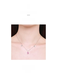 Detail of S925 silver Gemini necklace with pink water drop stone and engraved charms
