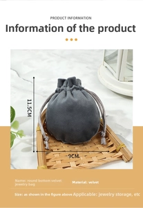 Close-up of grey velvet drawstring jewelry pouch on bamboo tray with marble background