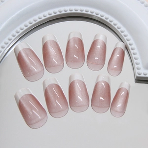Pink cat-eye press-on nails with white French tips in a long coffin shape set
