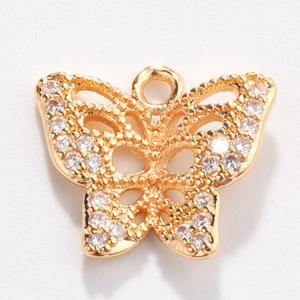 Macro shot of gold butterfly pendant charm set with sparkling white zircon stones