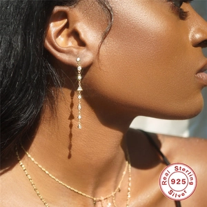 Elegant 925 sterling silver dangle earrings with round and triangle cubic zirconia on model