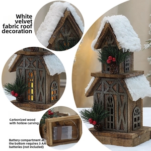 Detail view of carbonized wooden house with snowy roof and LED light for Christmas