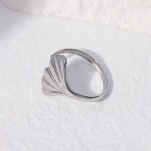 Macro shot of silver ginkgo leaf stainless steel ring showing smooth metal details