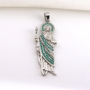 Macro shot of silver-plated St. Jude pendant with green micro-pave cubic zirconia