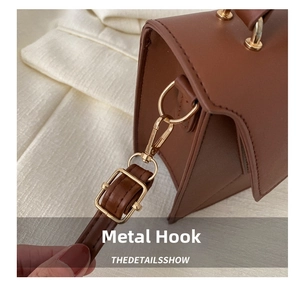 Detail of high-quality gold hardware hook and leather strap on stylish brown crossbody bag