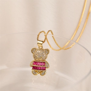 Close-up of golden bear pendant with sparkling zircon inlay on a delicate box chain