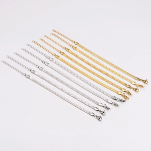 Sleek gold and silver flat snake chain bracelets in various widths on white backdrop