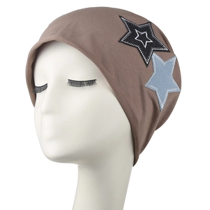 Brown knit beanie featuring star patches and ear protection in a retro streetwear style