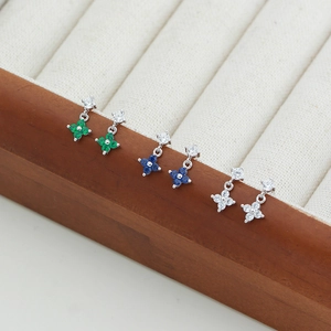 Detail view of s925 silver clover earrings with zircon in green, blue and white colors