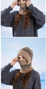 Close-up of khaki knitted winter hat with integrated neck gaiter and faux fur trim detail