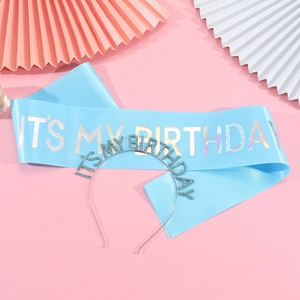 Light blue birthday sash with silver rhinestone tiara set on pink background