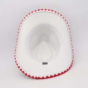Top down view of white western cowboy hat with red wavy brim trim and sweatband