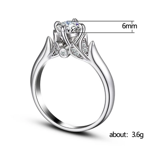Classic 6-prong silver ring with 6mm AAA cubic zirconia and leaf-shaped diamond accents