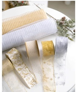 Detail of Christmas ribbon rolls and mesh set with gold snowflakes and metallic patterns