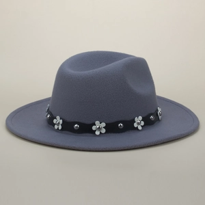 Close-up of gray felt fedora hat featuring white flower appliques and silver rivet band