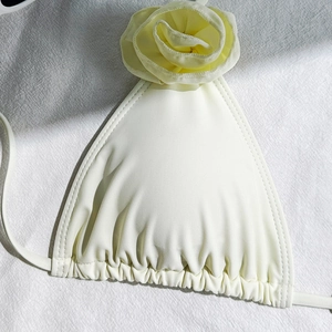 Detail of cream white bikini top with 3D rose flower and ruched drawstring edges