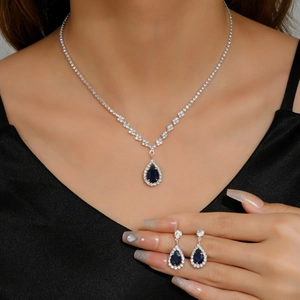 Exquisite silver necklace and earrings set with deep blue teardrop zircon gemstones