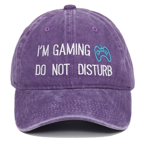 Detail of gaming embroidery on washed purple cotton baseball cap with controller icon