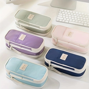 Close-up of assorted macaron-colored pencil cases in green, purple, pink, and blue shades