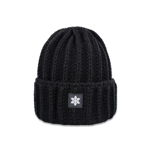 Detail of black vertical ribbed knit beanie featuring a white snowflake patch on the cuff