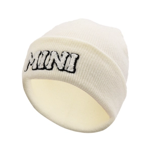 Close-up of cream knitted beanie featuring black and white MINI letter embroidery detail