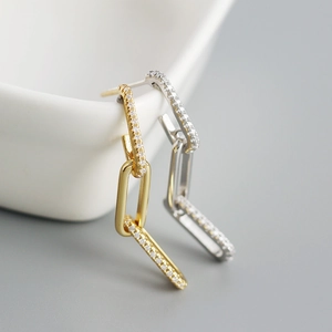 Detail of s925 silver chain tassel earrings with gold and silver paved zircon stones