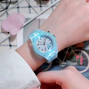 Close-up of light blue LED luminous quartz watch with silicone strap and balloon dial