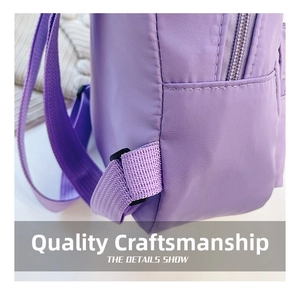 Detailed view of stitching and durable nylon fabric on the light purple backpack side