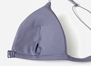 Detail of purple ribbed bra with seamless knit texture and back hook closure
