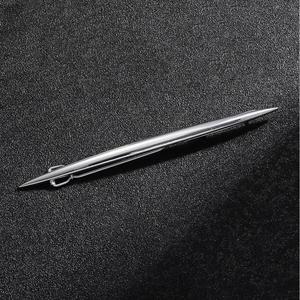 Macro shot of silver metal ballpoint pen with sleek texture on a black background