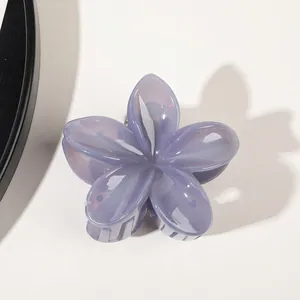 Top view of a lavender translucent flower hair claw clip with a glossy resin finish