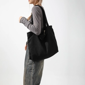Large black corduroy tote bag for women showing a casual lifestyle slouchy shoulder style