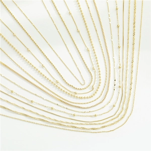 Collection of various golden stainless steel link chains including box and cable styles