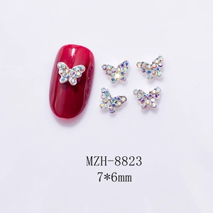Macro view of 7x6mm mini metal butterfly nail charms with colorful iridescent rhinestones