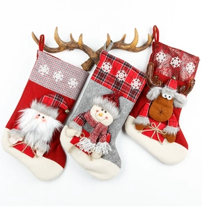 Detailed view of three large Christmas stockings featuring Santa, Snowman, and Reindeer